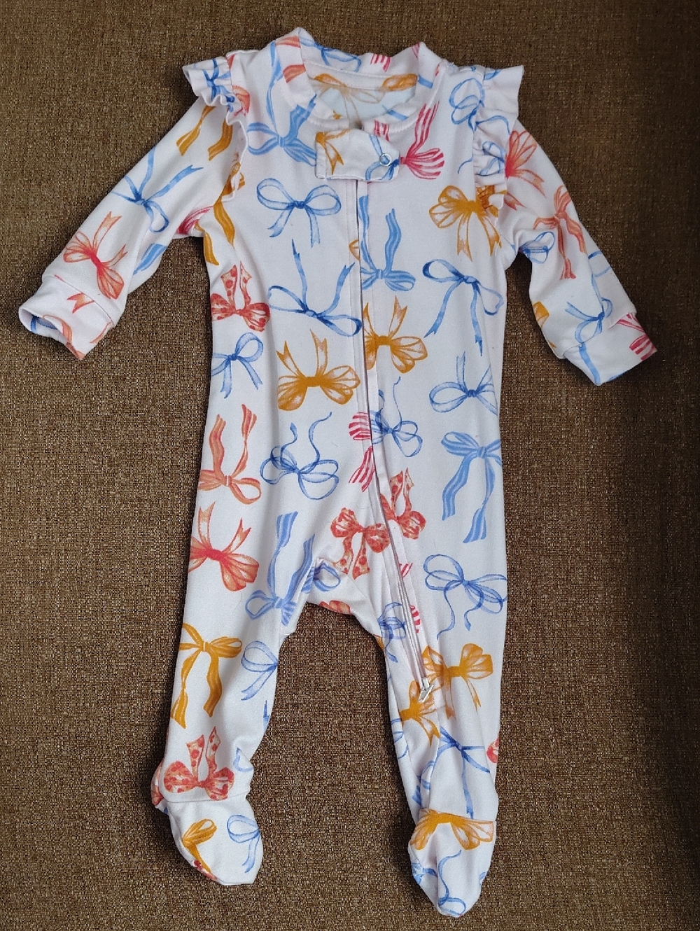 Paris Hilton White Footed Baby One-Piece with Blue, Pink and Yellow Bow Print